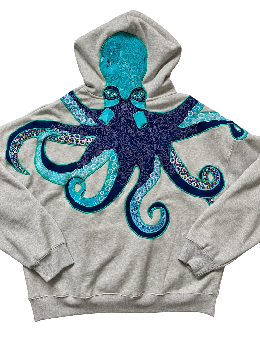 Editorial presentation of Chili’s original folded-sleeve octopus hoodie with layered cloth tentacles.