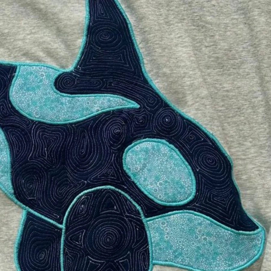 Teal patterned cloth and navy stitching in Chili’s sewn orca